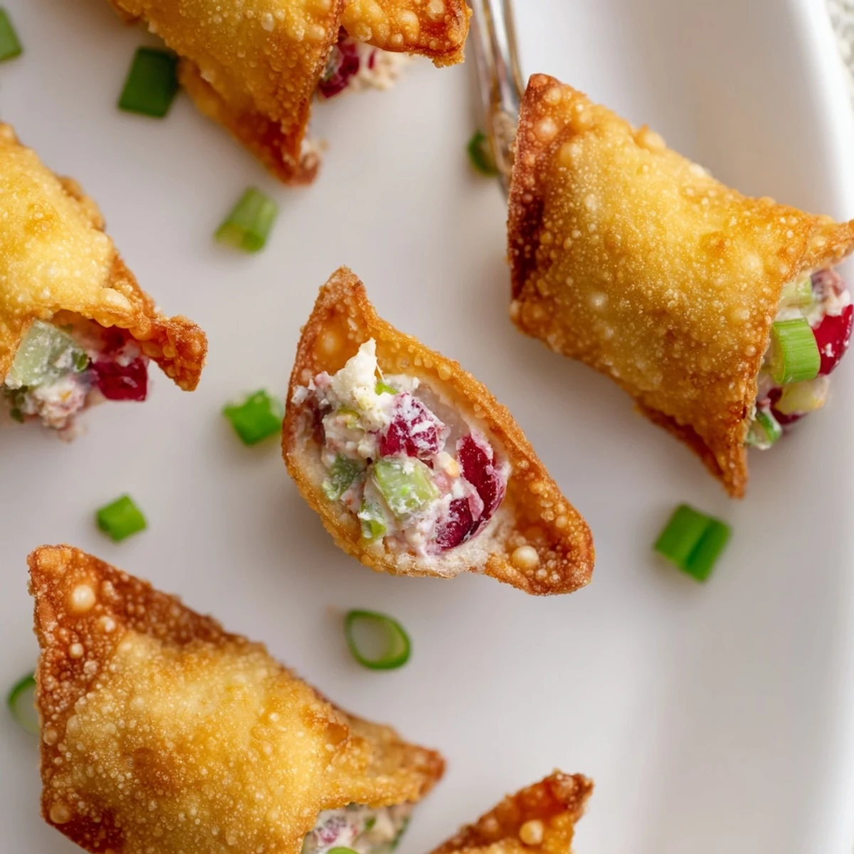 Cranberry Jalapeño Dip Poppers served on a festive platter, garnished with green onions.  