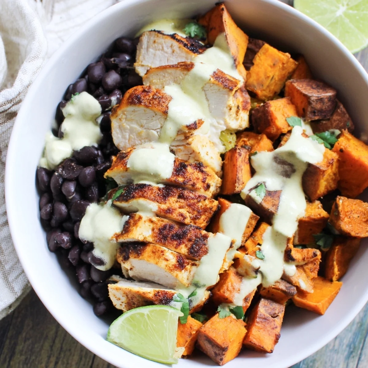 A vibrant Chipotle Chicken Bowl with Black Beans and roasted sweet potatoes awaits.  