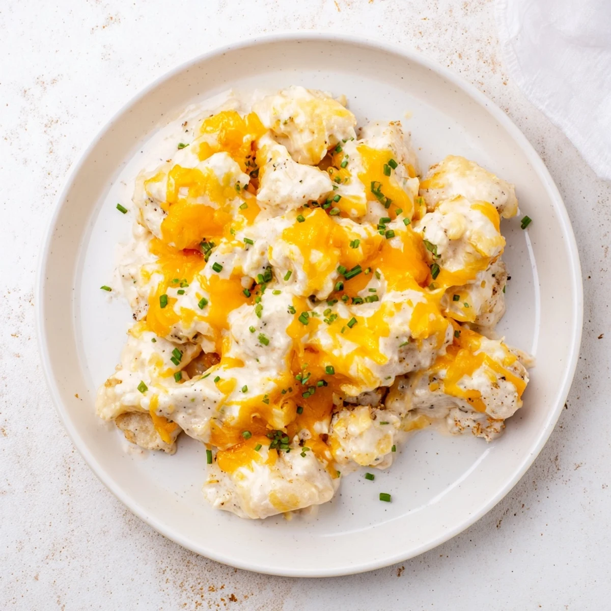 Golden, bubbly Cheddar Ranch Chicken Bake topped with melted cheese, ready for a delicious dinner.