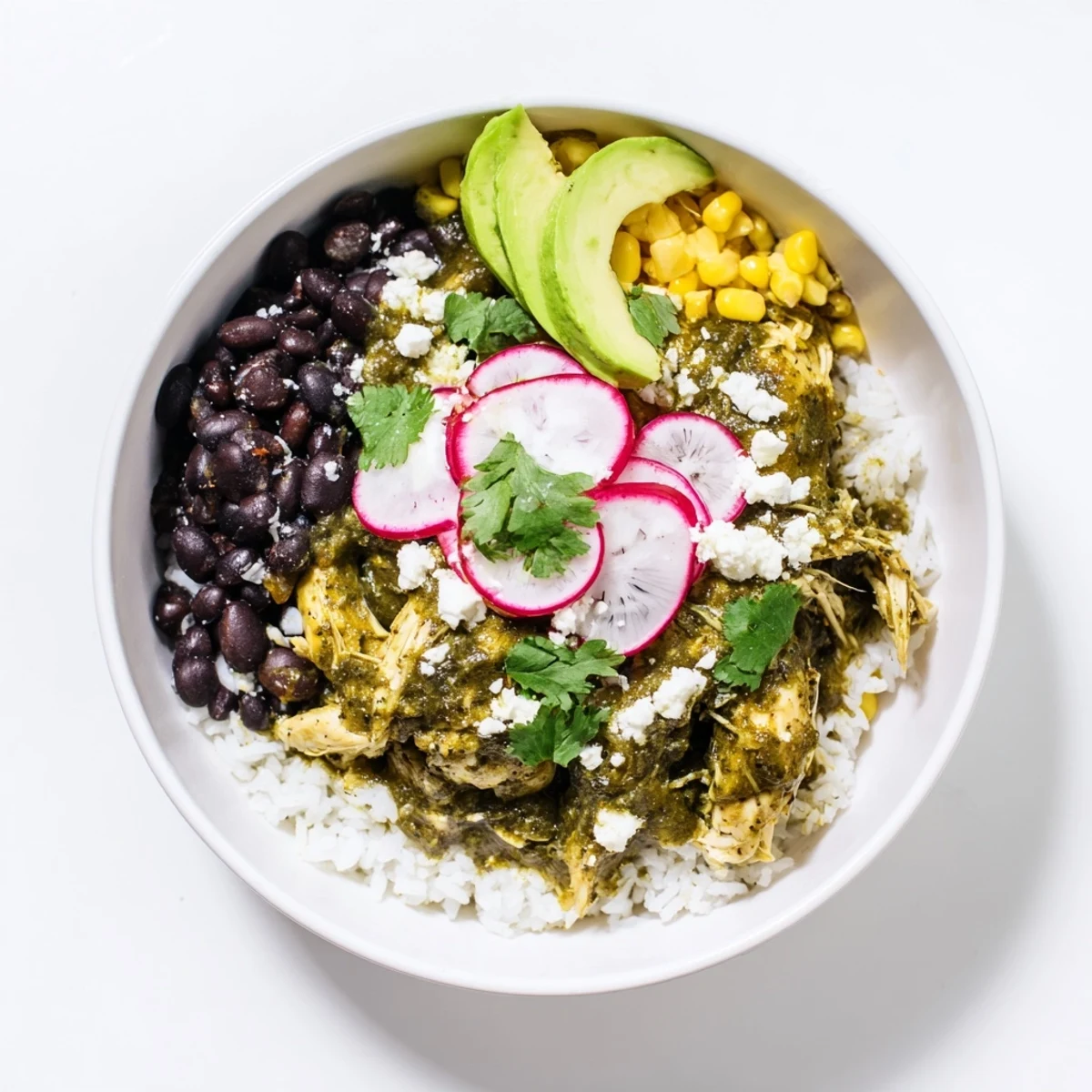 Green Enchiladas Rice Bowl brimming with tender chicken, vibrant toppings, and creamy avocado, perfect for dinner.