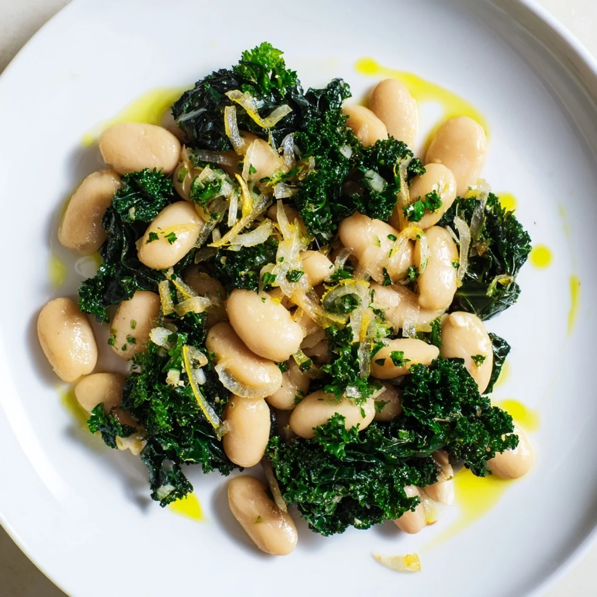 Steaming bowl of garlicky beans with winter greens, a bright and flavorful Mediterranean meal.