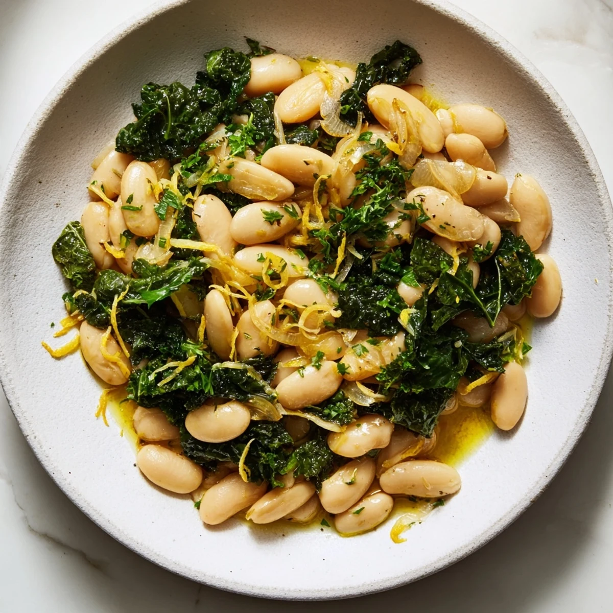 Fragrant, garlicky beans with winter greens in a warm skillet, a satisfying vegetarian main.
