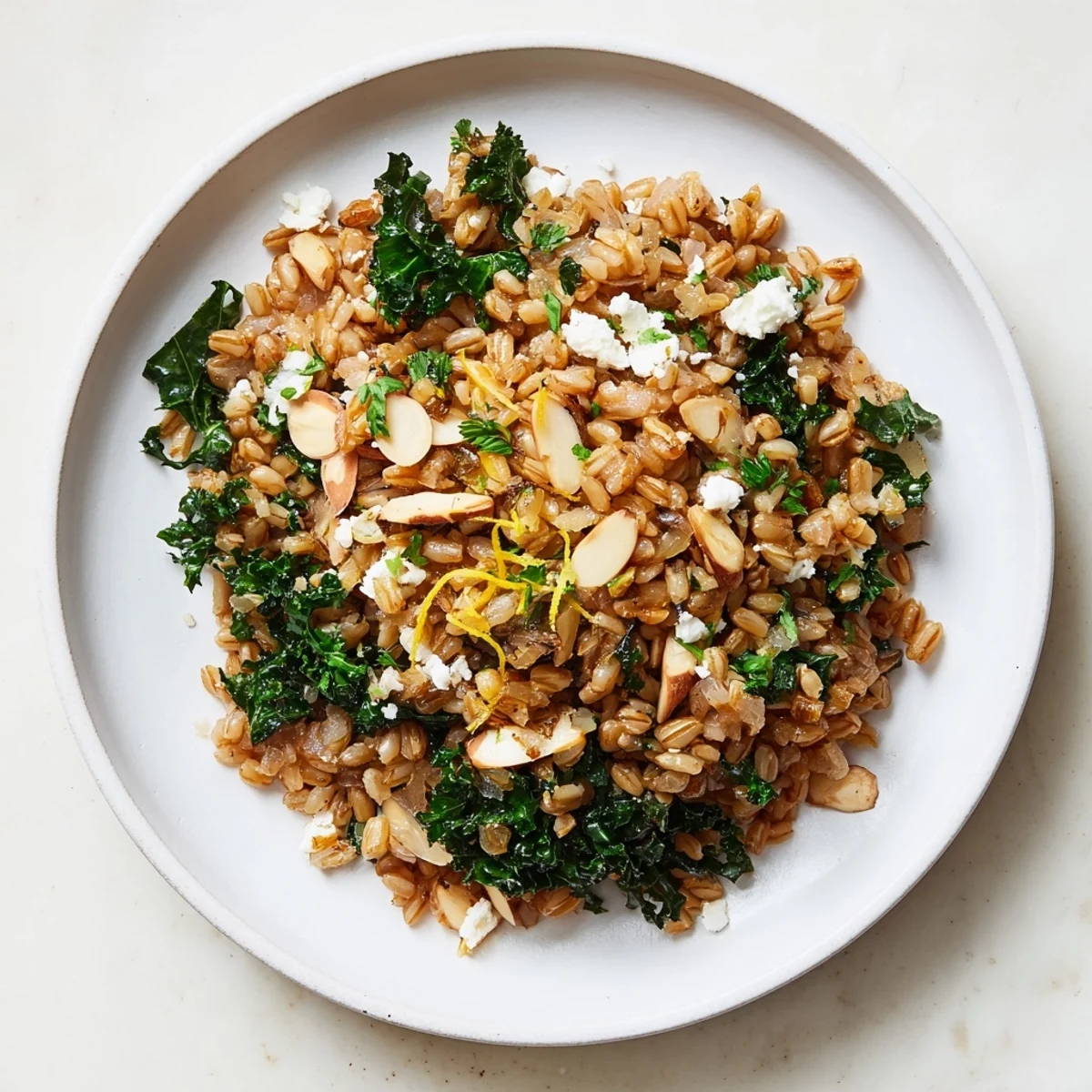 A close-up of a rustic, satisfying Warm Farro & Greens Pilaf, perfect for a vegetarian meal.