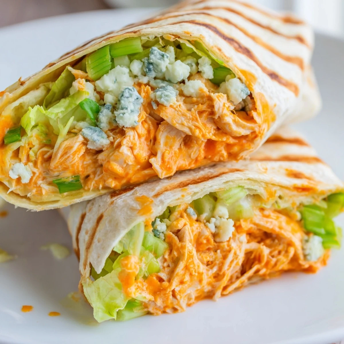 Warm, golden Buffalo Chicken Dip Wraps, generously stuffed and ready to be sliced and devoured.