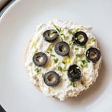 Quick and easy Gold Medal Olympic Ring Appetizers, featuring a creamy base topped with sliced olives and peppers.