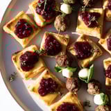 A beautiful spread featuring the Joy to the World Festive Appetizer Trio, ready to be enjoyed at a holiday party.
