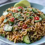 Chilled sesame noodles with crisp cucumber, carrots, and herbs in a rich, nutty dressing for summer.  