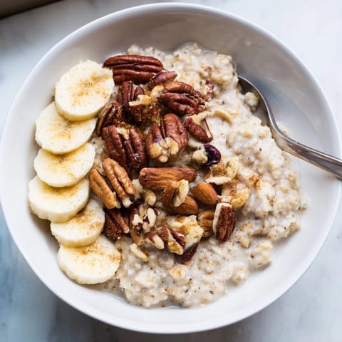 Close-up of warm Protein Cinnamon Crunch Oatmeal, highlighting its creamy texture and crunchy topping.
