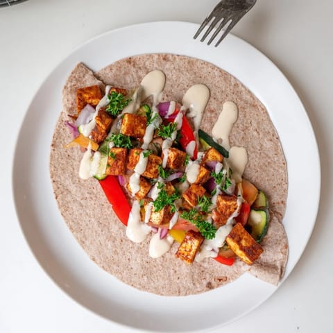 Delicious vegan viral recipe re-make wrapped in whole wheat pita, drizzled with sauce.  