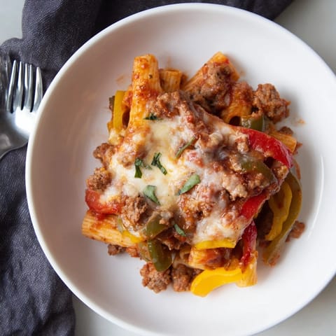 Delicious Baked Rigatoni with Sausage & Peppers, bubbling with savory tomato sauce and cheese.  