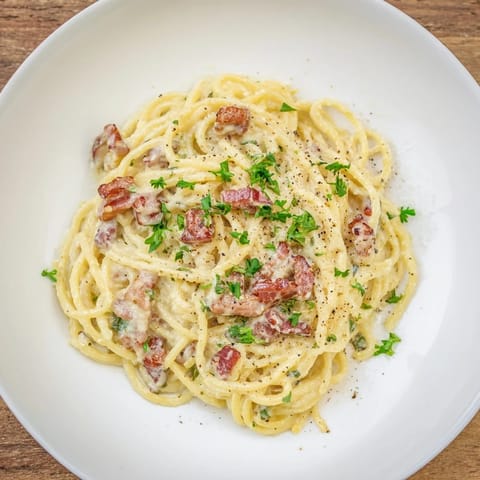 Close-up of the finished Instant Pot Carbonara Ramen Hack, rich with egg yolk and cheesy sauce.
