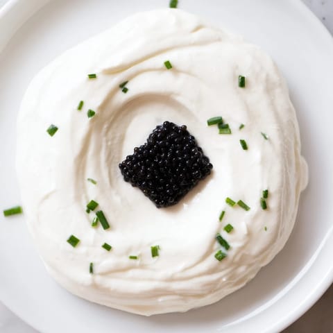 Imagine this: The Diamond Inlay, a stunning appetizer with caviar, surrounded by fluffy cream cheese and herbs.