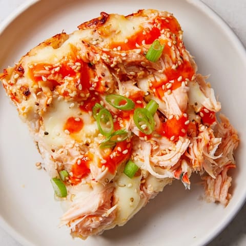 Deconstructed Creamy Salmon Sushi Bake with flaked salmon and creamy sauce, a perfect family meal.