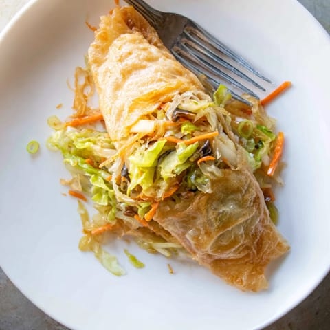 These crispy rice paper dumplings showcase a perfectly fried, textured surface with a flavorful blend.