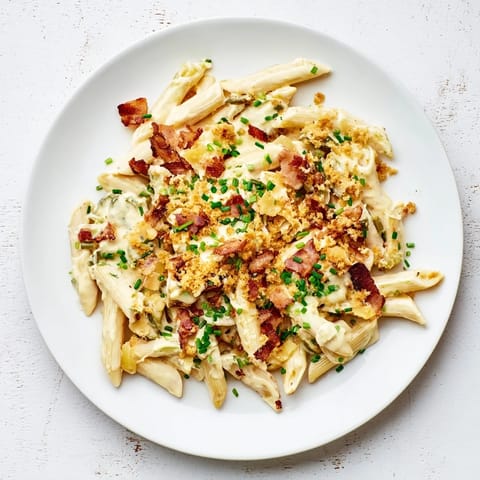Jalapeño Popper Pasta served in a warm bowl, topped with toasted panko and fresh chives.