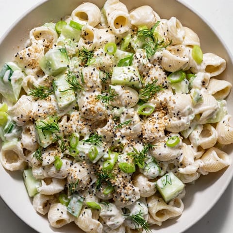 Chilled Cucumber Crunch Pasta Salad featuring tender small shells tossed with creamy dressing, green onions, and everything bagel seasoning for a refreshing summer side.