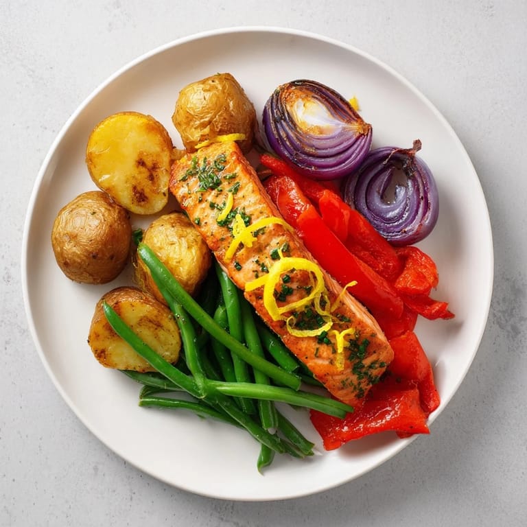 This delicious sheet pan features flaky Lemon Herb Salmon alongside roasted potatoes and colorful bell peppers.