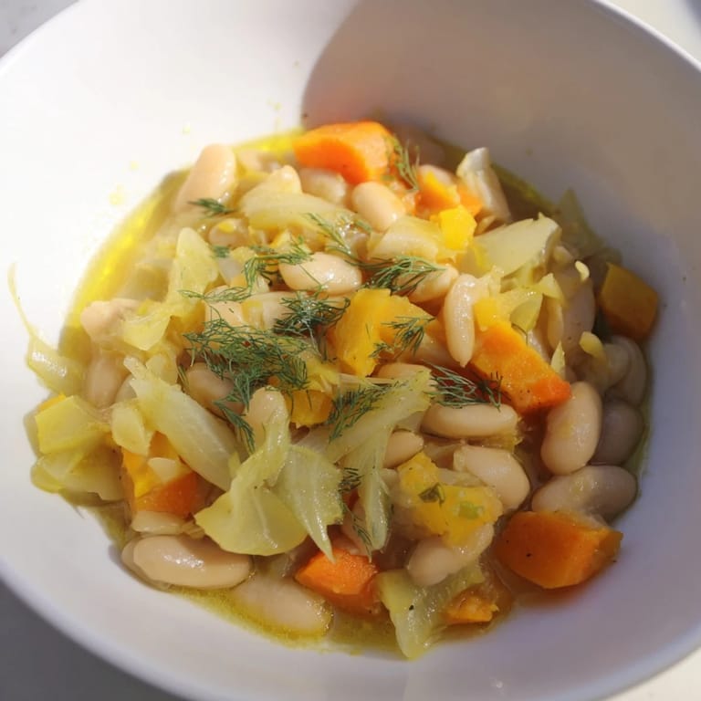 A bowl of Simple White Bean and Fennel Soup, rustic and fragrant, with a drizzle of olive oil.