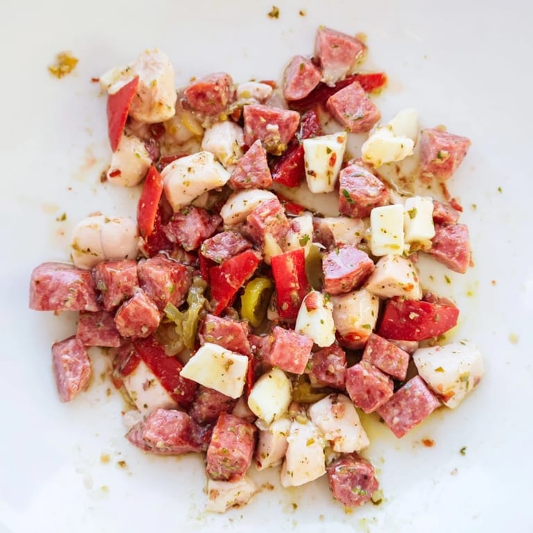Overhead view of Italian Deli Chopped Chicken Salad featuring diced cucumber, pepperoncini, and cherry tomatoes, ready to serve as a hearty main dish.