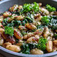 A vibrant vegan skillet dish with creamy white beans, fresh spinach, and zesty lemon-garlic sauce. A quick, healthy, and protein-rich meal.